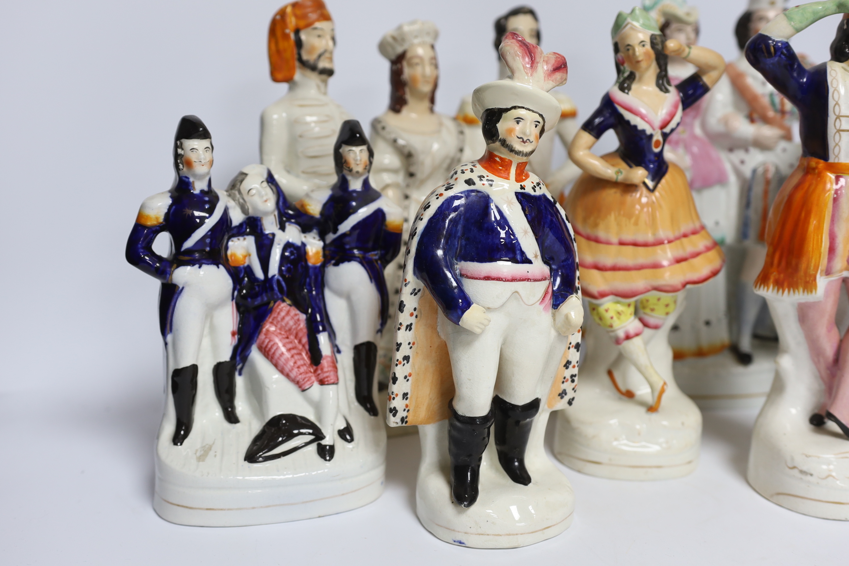 Seven 19th century Staffordshire flat back figure groups, including figures of Milton, Nelson, a pair of dancers, etc., tallest 29cm